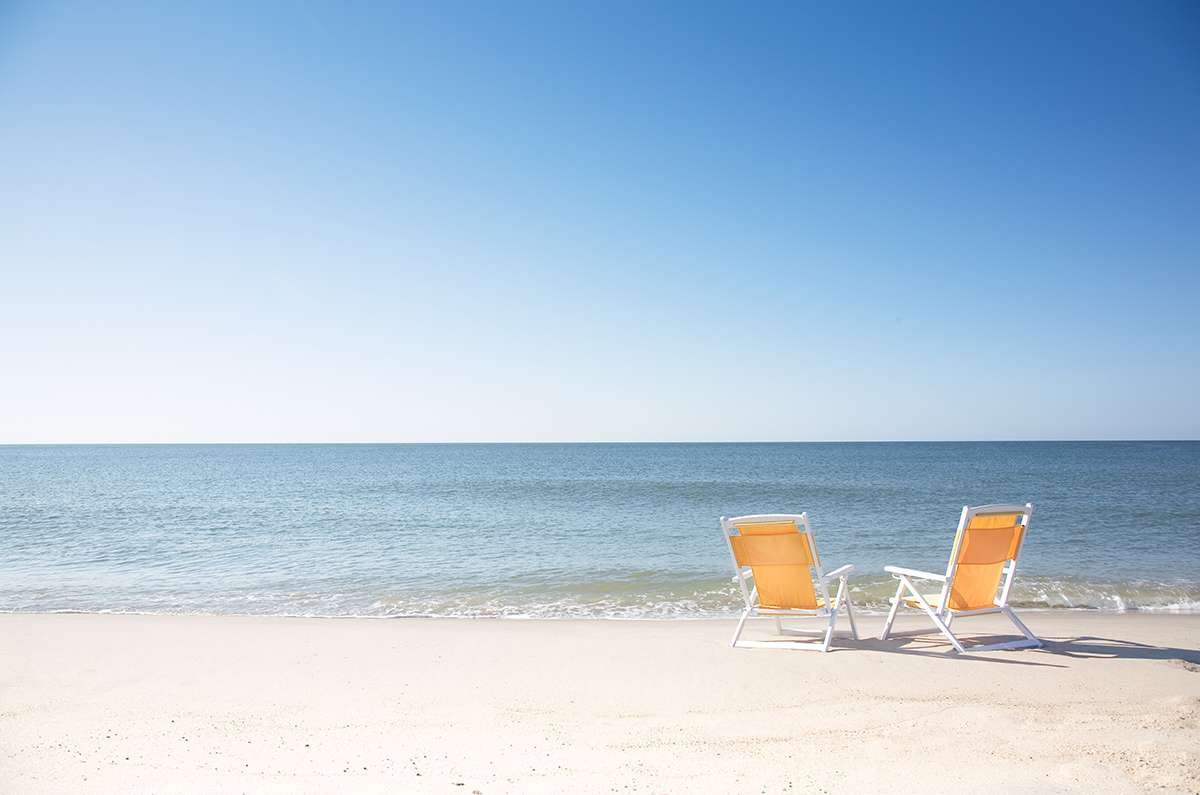 Two beach chairs on empty Surfside Beach