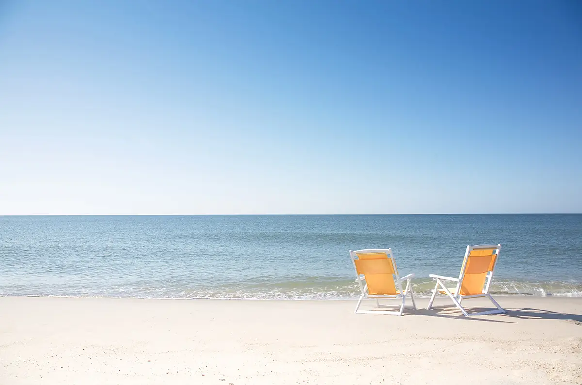 Two beach chairs on empty Surfside Beach